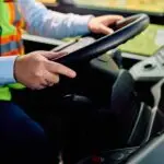 Close up of school bus driver driving a bus.